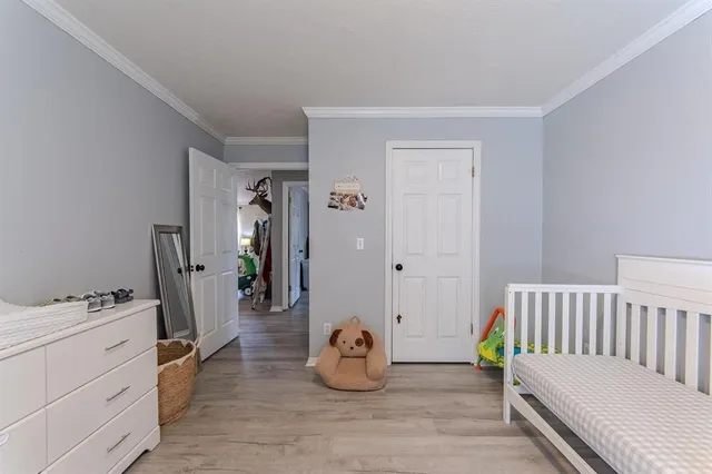 a bedroom with furniture and a wooden floor