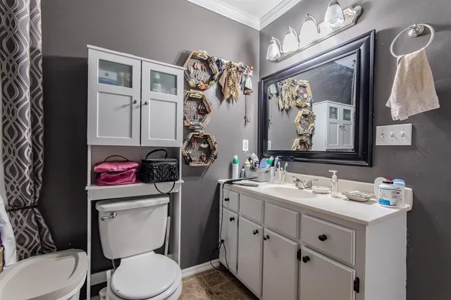 a bathroom with a sink toilet vanity and shower