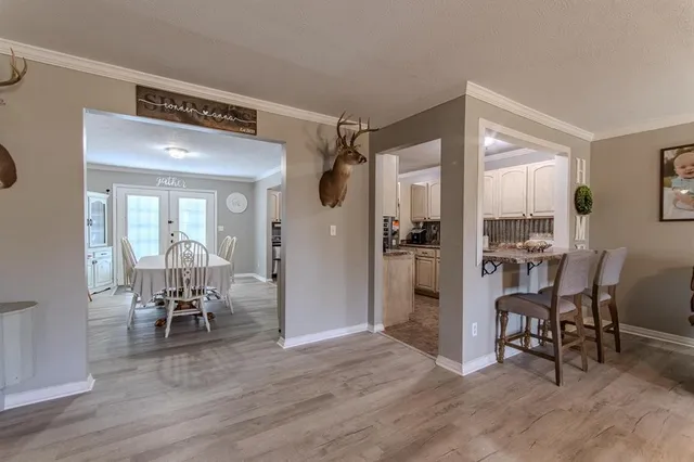 a view of a room with wooden floor and furniture