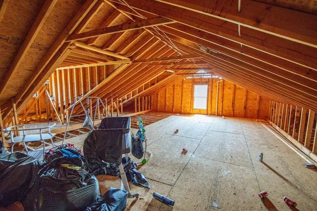 a view of a big house with wooden fence
