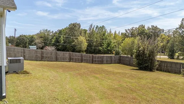a swimming pool with trees in front of it