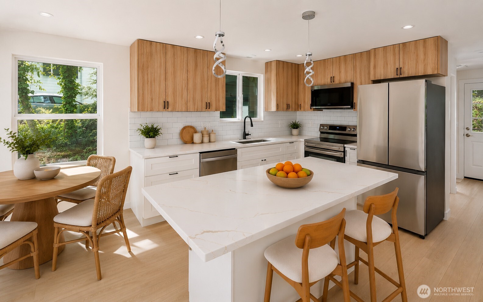 7605 Northeast Hidden Cove Road Bainbridge Island, WA 98110 - Photo 4 of 36 a kitchen with a dining table and chairs