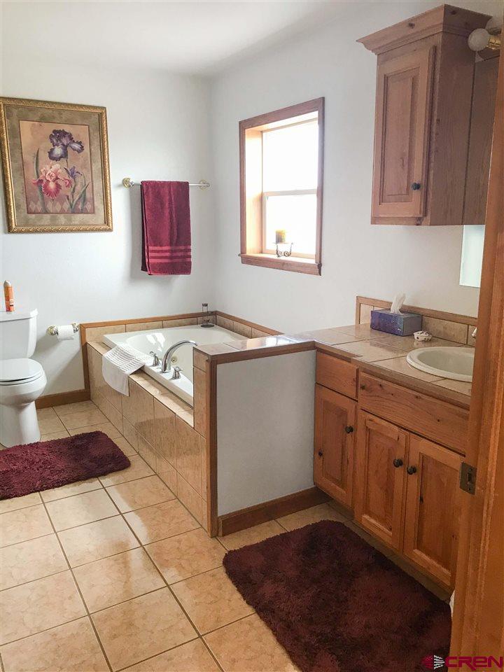 34354 3575th Road Redvale, CO 81431 - Photo 12 of 30 a kitchen with a sink stove and cabinets
