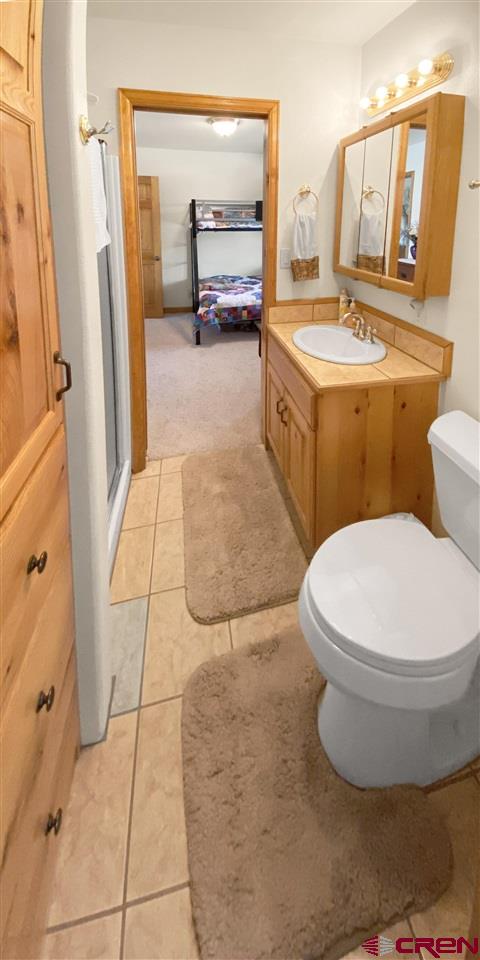 34354 3575th Road Redvale, CO 81431 - Photo 16 of 30 a bathroom with a granite countertop toilet sink and mirror