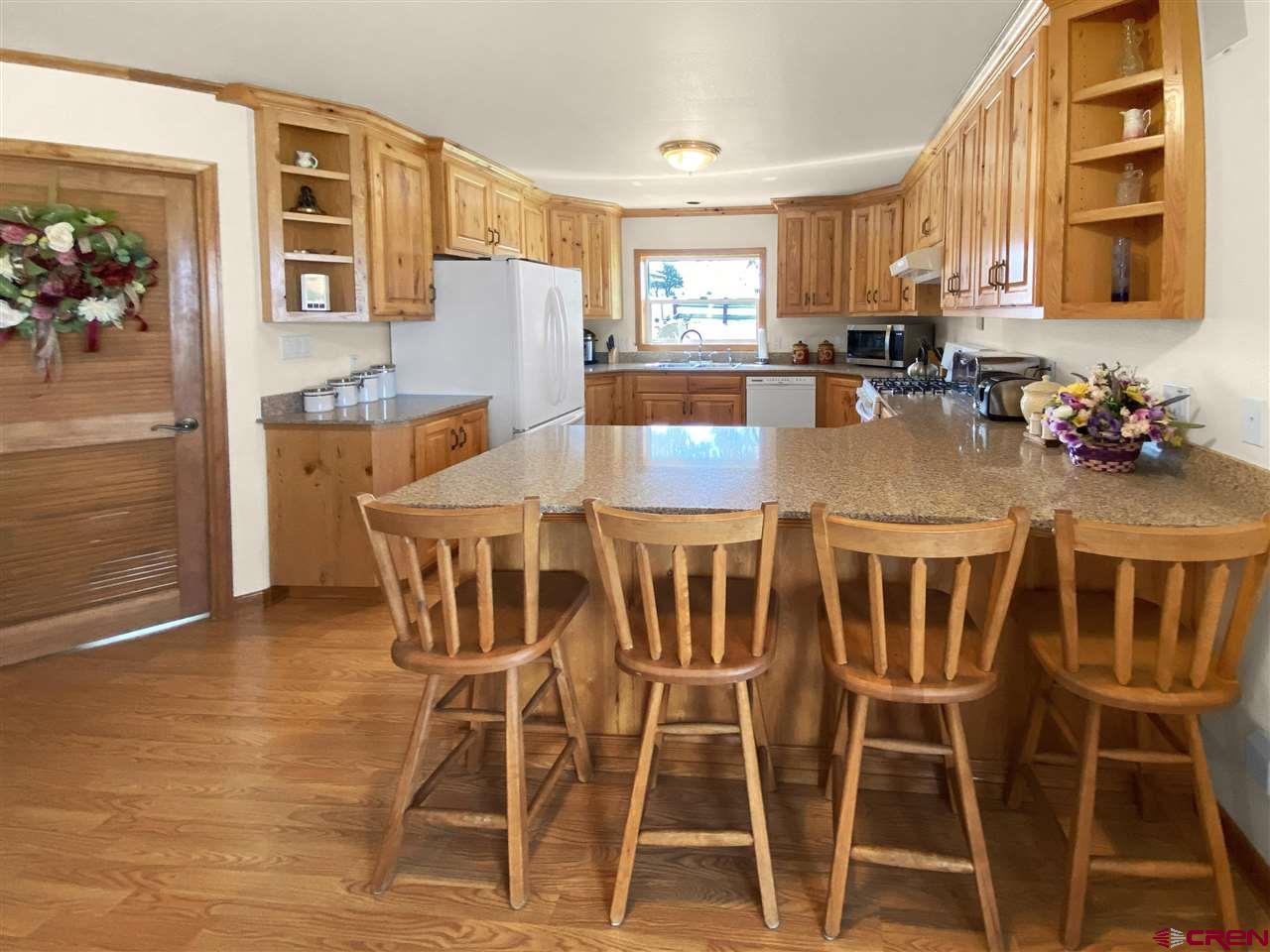 34354 3575th Road Redvale, CO 81431 - Photo 5 of 30 a view of a dining room with furniture and a chandelier