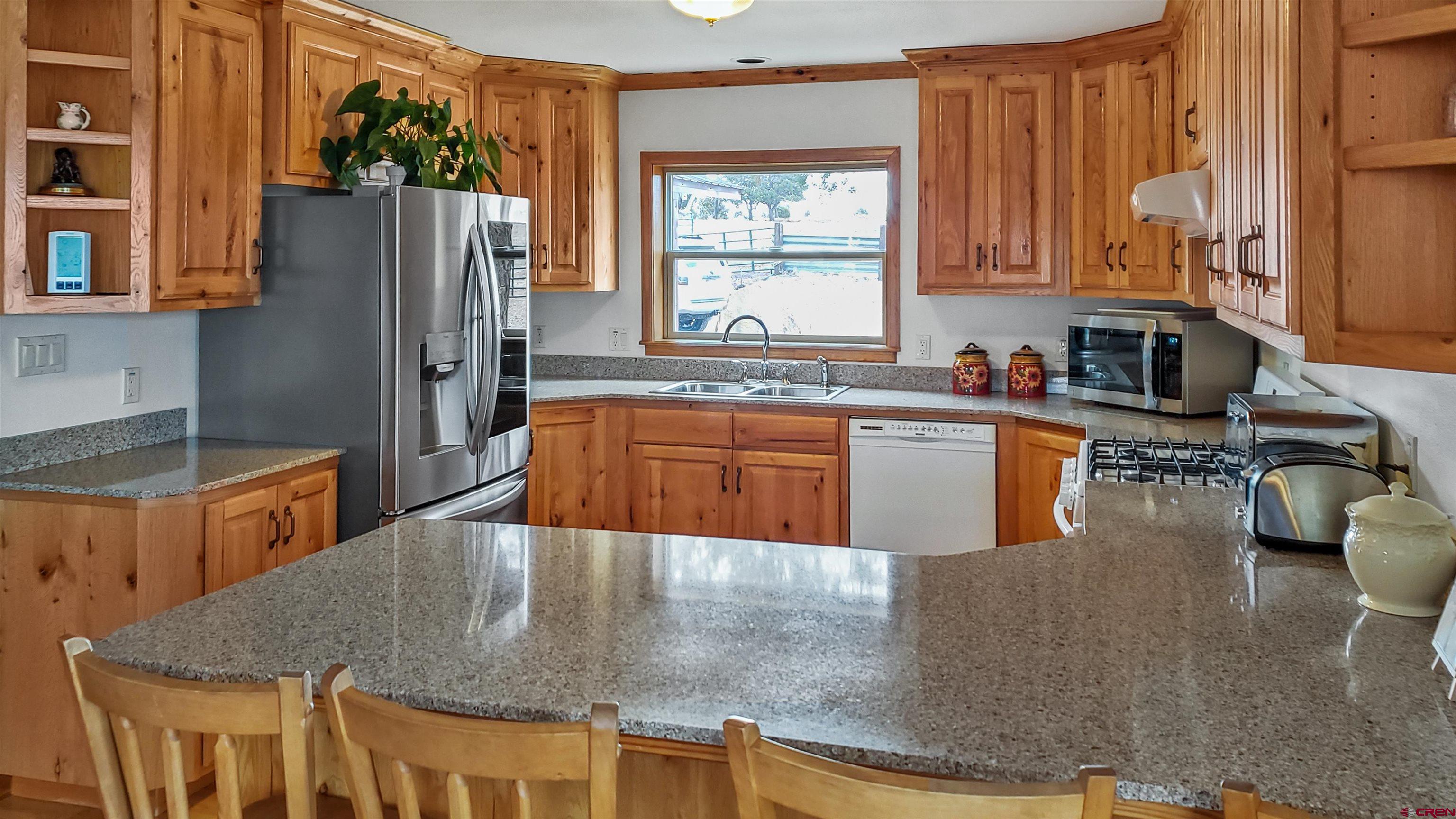 34354 3575th Road Redvale, CO 81431 - Photo 6 of 30 a kitchen with stainless steel appliances granite countertop a sink a stove and refrigerator