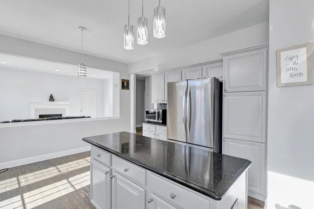 a kitchen with stainless steel appliances granite countertop a refrigerator a sink and a stove