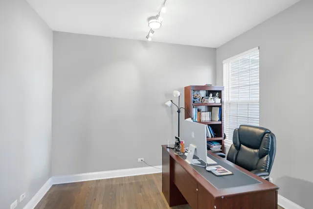 a living room with furniture and a book shelf