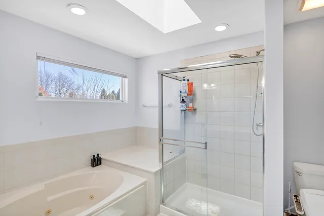 a bathroom with a bathtub a sink and a mirror