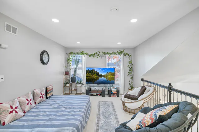 a bedroom with a bed and a lamp