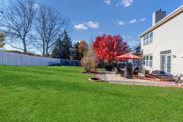a front view of a house with a yard and fountain in middle