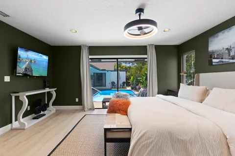 a bedroom with a bed and a large mirror