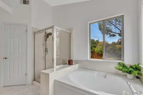 a white bath tub sitting next to a shower