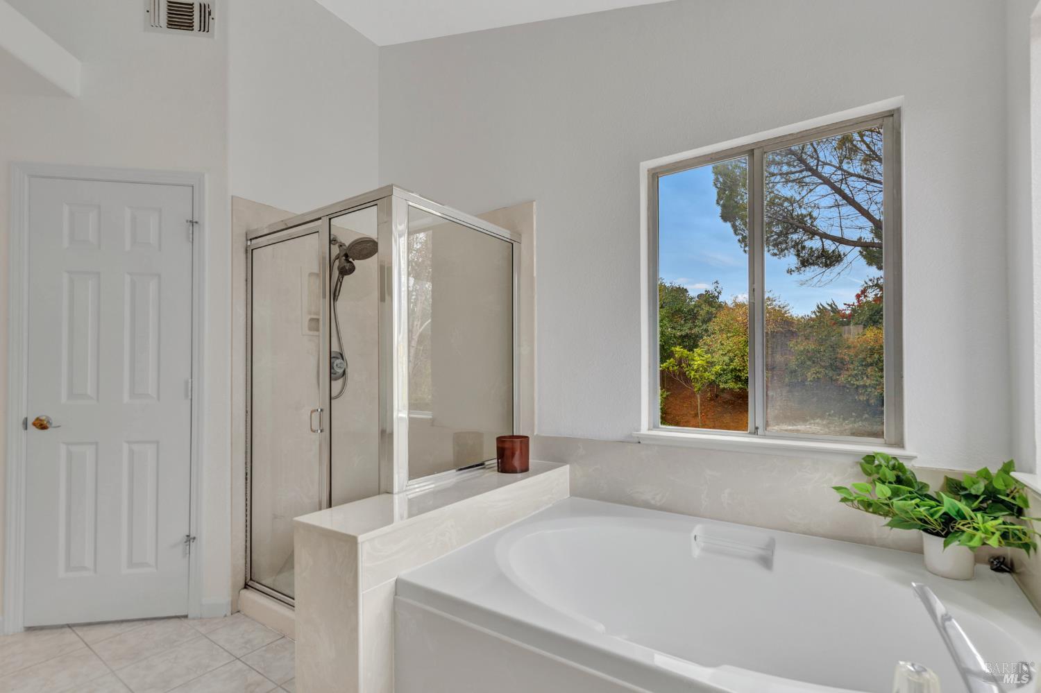 131 Sheila Court Vallejo, CA 94591 - Photo 17 of 36 The primary bath offers a tranquil retreat with a luxurious sunken tub, a separate shower, dual sinks, and a private toilet closet for added convenience and privacy.