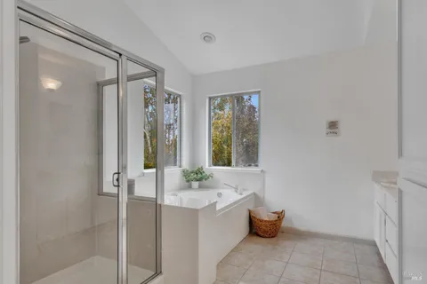 a bathroom with a tub shower and sink
