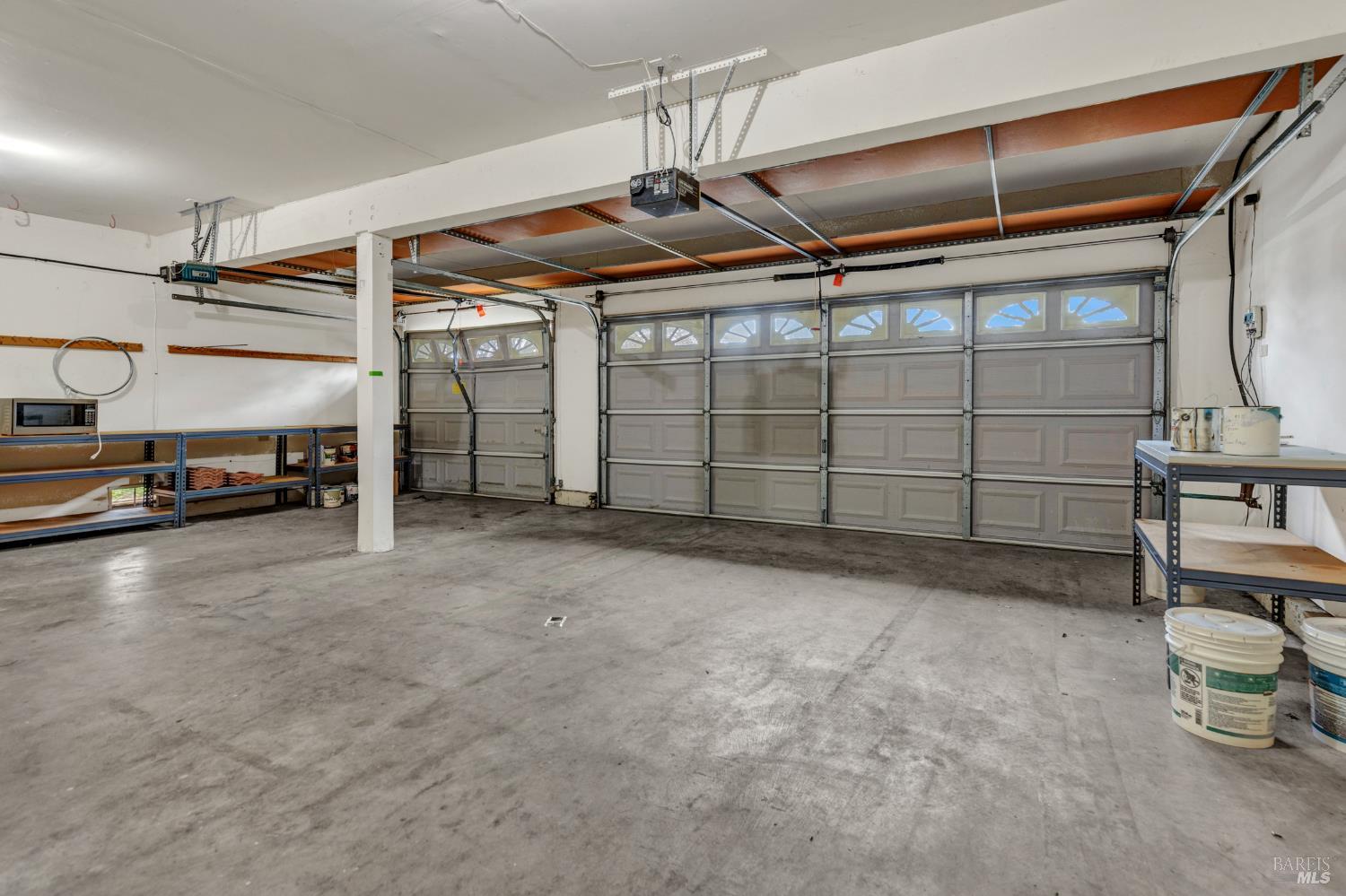 131 Sheila Court Vallejo, CA 94591 - Photo 28 of 36 This three-car garage offers plenty of space for vehicles, storage, and even a small workshop. It's designed to accommodate a variety of needs, whether you're looking to store multiple cars or need extra room for equipment and tools. The space is an excellent addition to this property.