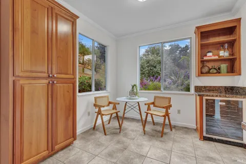 a dining room with furniture and a window