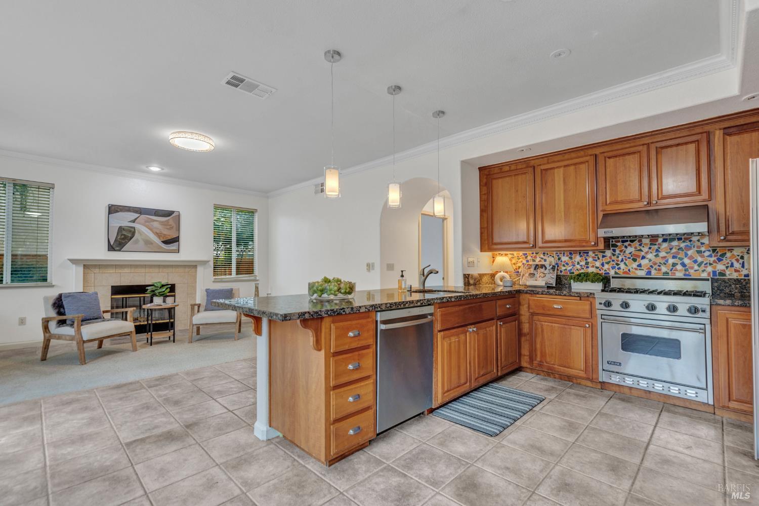 131 Sheila Court Vallejo, CA 94591 - Photo 9 of 36 Experience the charm of an L-shaped kitchen that overlooks a sunlit den. This space is filled with natural light, creating a warm and inviting atmosphere perfect for both cooking and relaxation.