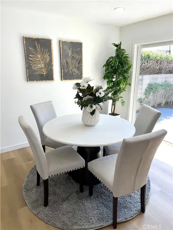 a dining room with furniture and wooden floor