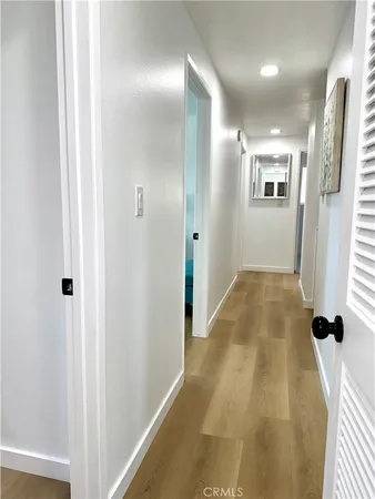 a view of hallway with wooden floor
