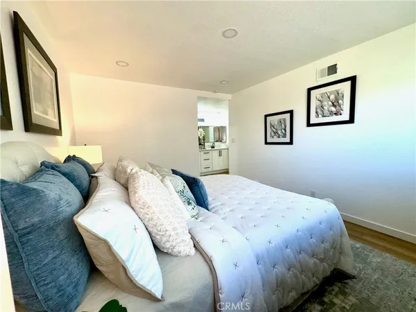 a bedroom with a bed and glass windows