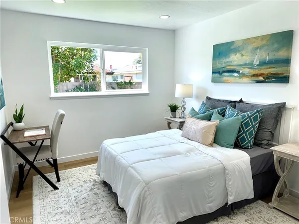 a bedroom with a bed and a chair