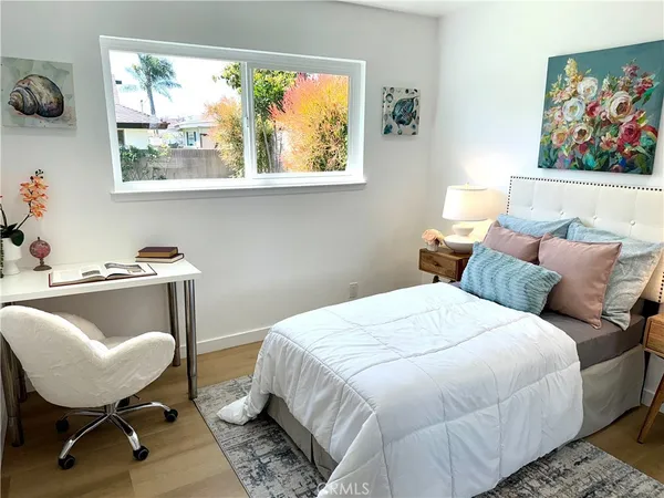 a bedroom with bed and wall painting