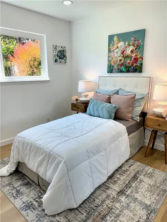 a bathroom with a granite countertop toilet sink and mirror