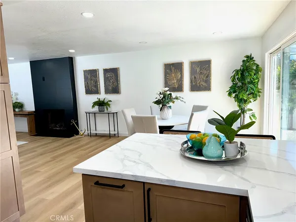 a dining table seating room with kitchen island furniture and wooden floor
