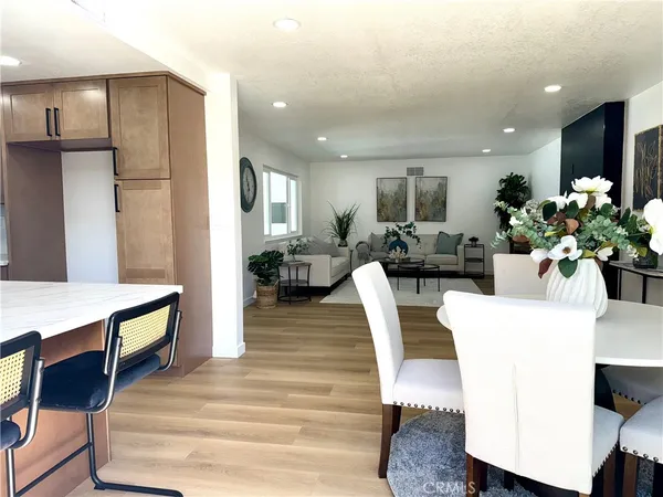 a living room with furniture flowerpot and a chandelier