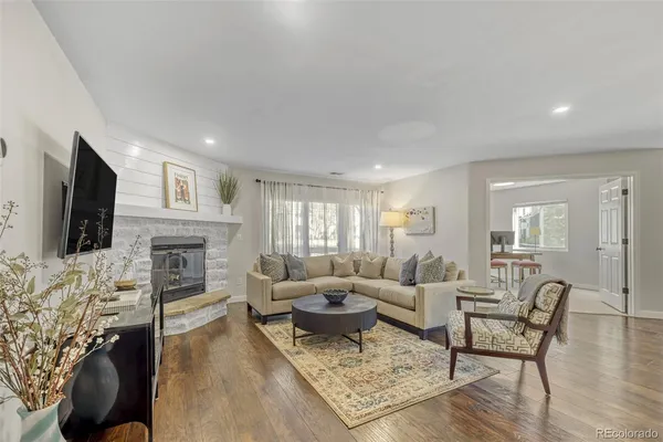 a living room with fireplace furniture and a flat screen tv