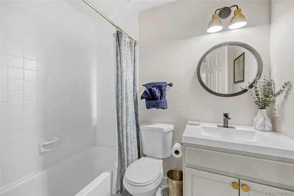 a bathroom with a toilet a sink and a mirror