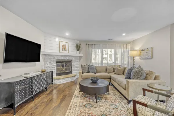 a living room with fireplace furniture and a flat screen tv