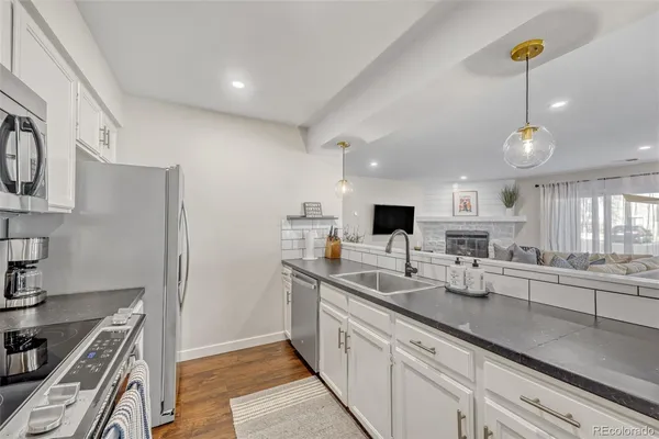 a kitchen with counter top space cabinets and stainless steel appliances