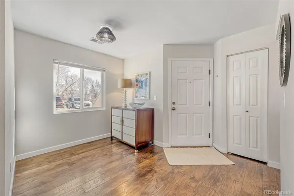 an empty room with windows and closet