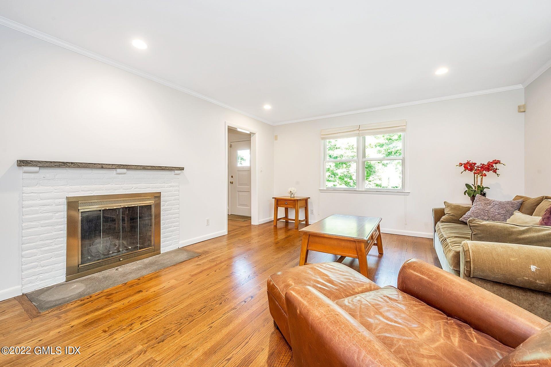 48 Valleywood Road Cos Cob, CT 06830 - Photo 2 of 25 a living room with furniture and a fireplace