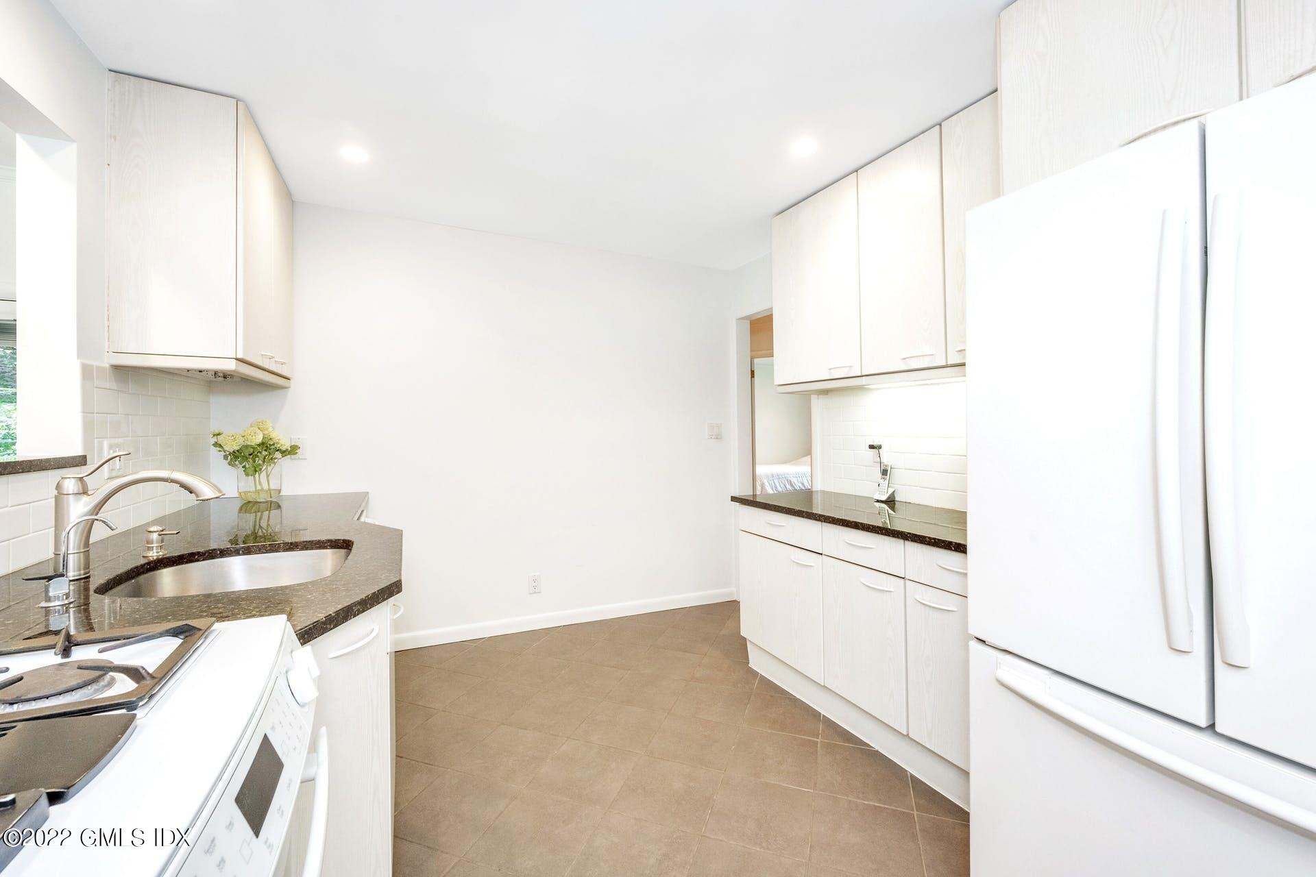 48 Valleywood Road Cos Cob, CT 06830 - Photo 6 of 25 a kitchen with granite countertop a sink and a stove top oven
