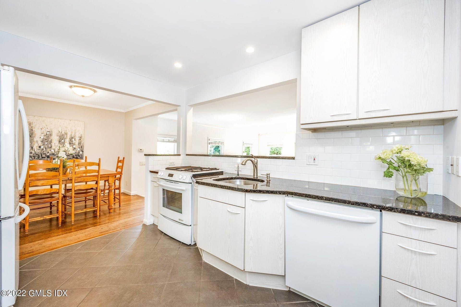 48 Valleywood Road Cos Cob, CT 06830 - Photo 7 of 25 a kitchen with granite countertop stainless steel appliances a sink and cabinets
