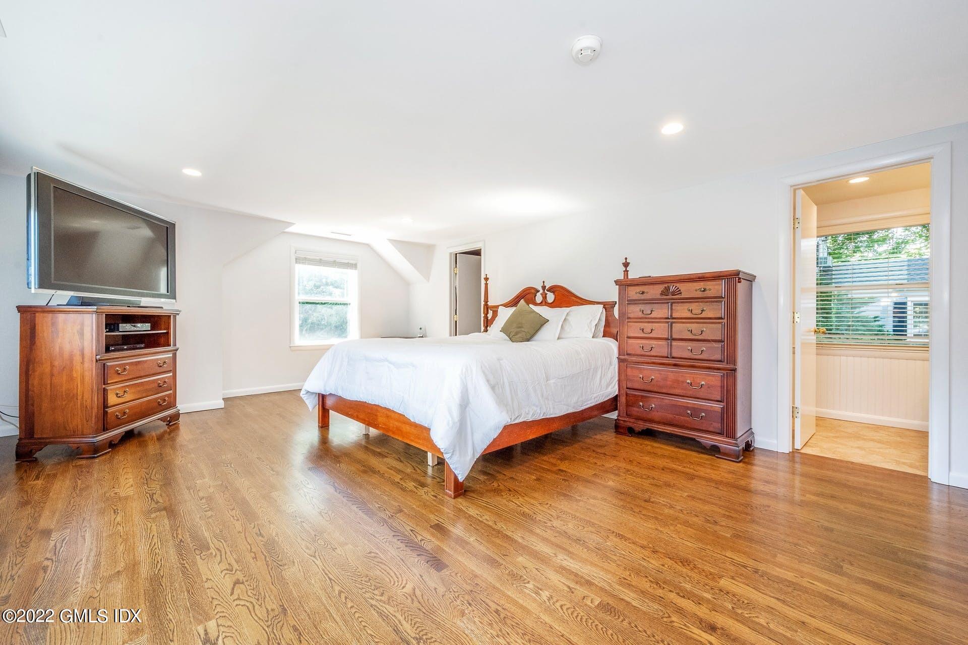 48 Valleywood Road Cos Cob, CT 06830 - Photo 8 of 25 a bedroom with a bed and wooden floor