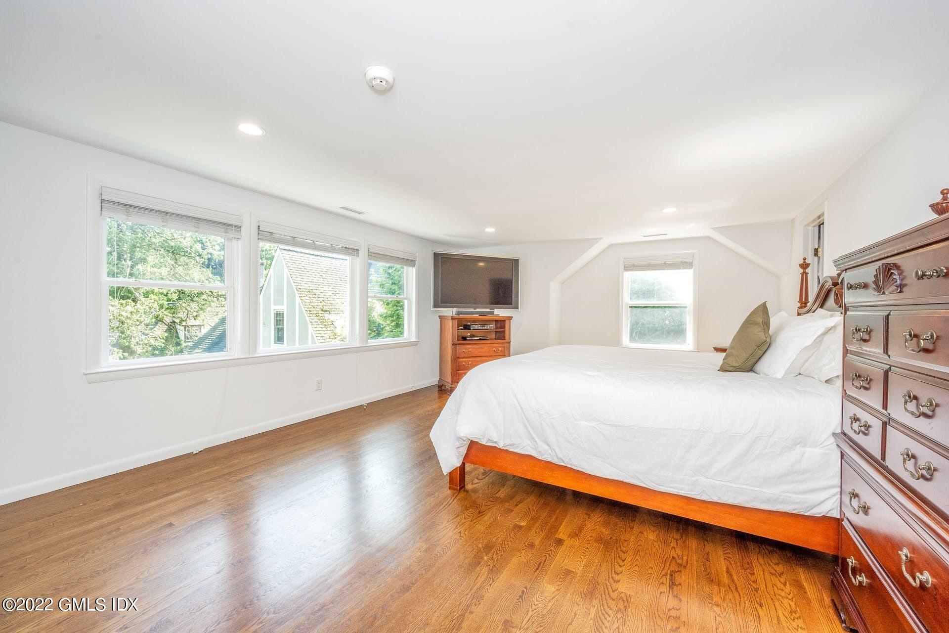 48 Valleywood Road Cos Cob, CT 06830 - Photo 9 of 25 a bedroom with a bed and wooden floor