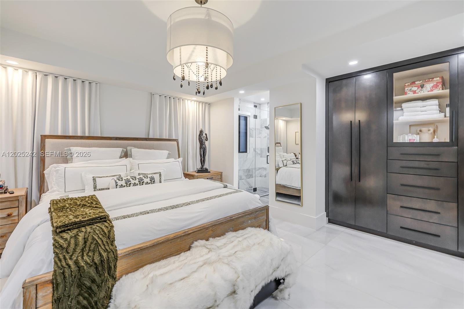 8761 Southwest 56th Street Miami, FL 33165 - Photo 32 of 90 a bedroom with a bed and a chandelier