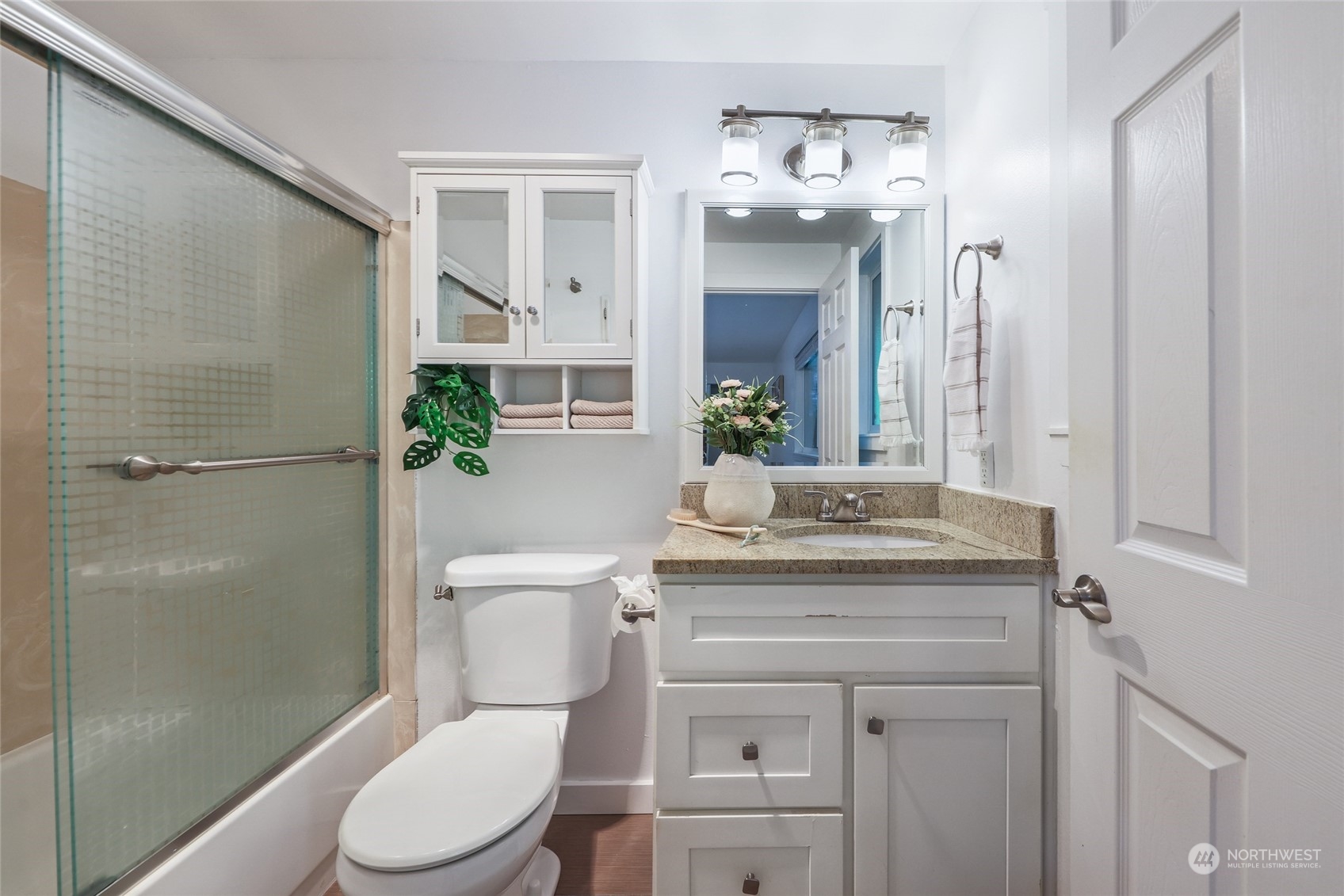 1211 232nd Place Southwest Bothell, WA 98021 - Photo 15 of 30 a bathroom with a granite countertop toilet sink and shower