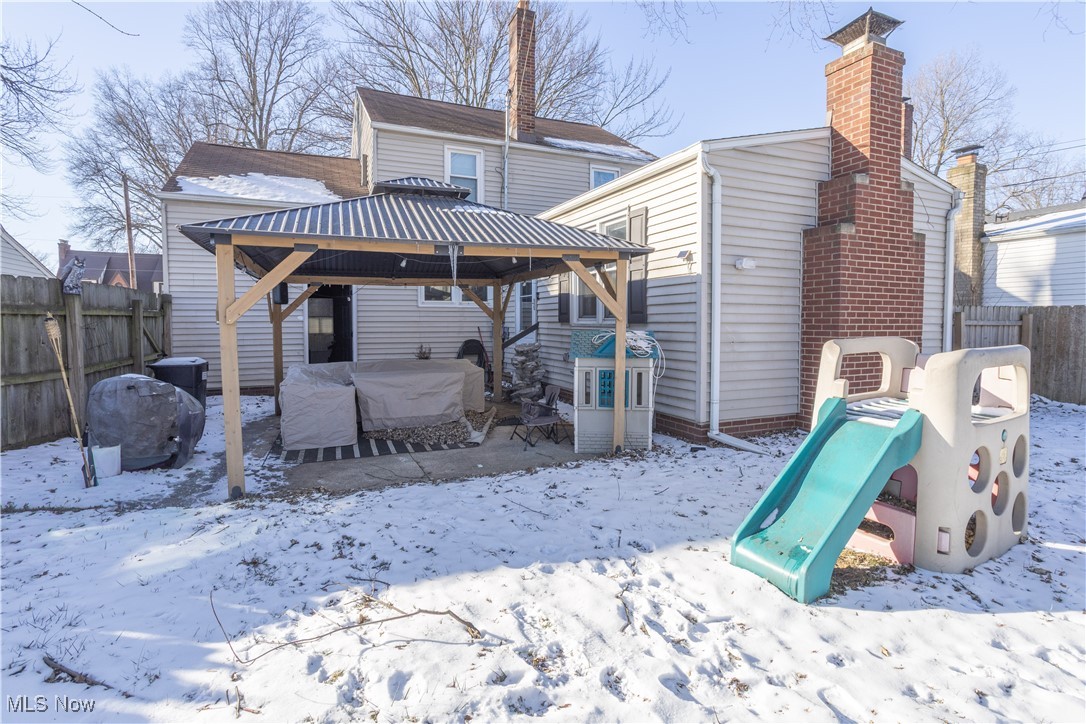 134 Raff Road Northwest Canton, OH 44708 - Photo 24 of 28 Snow covered rear of property featuring a gazebo, a patio area, and a playground