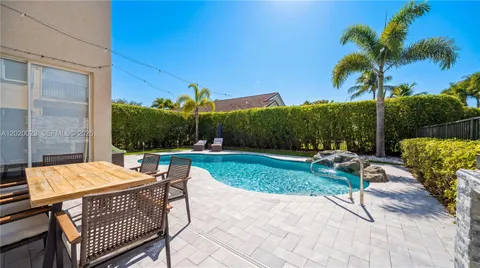 a view of backyard with seating area and green space