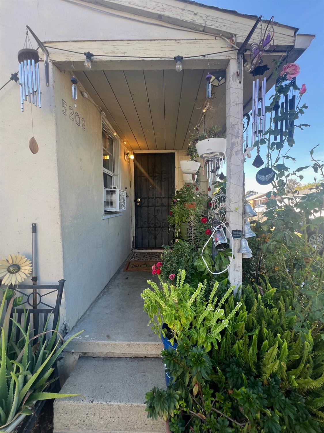 5202 Thurman Way Sacramento, CA 95824 - Photo 13 of 24 a house with potted plant in front of it