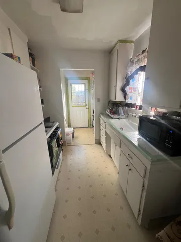 a kitchen with a sink appliances and cabinets
