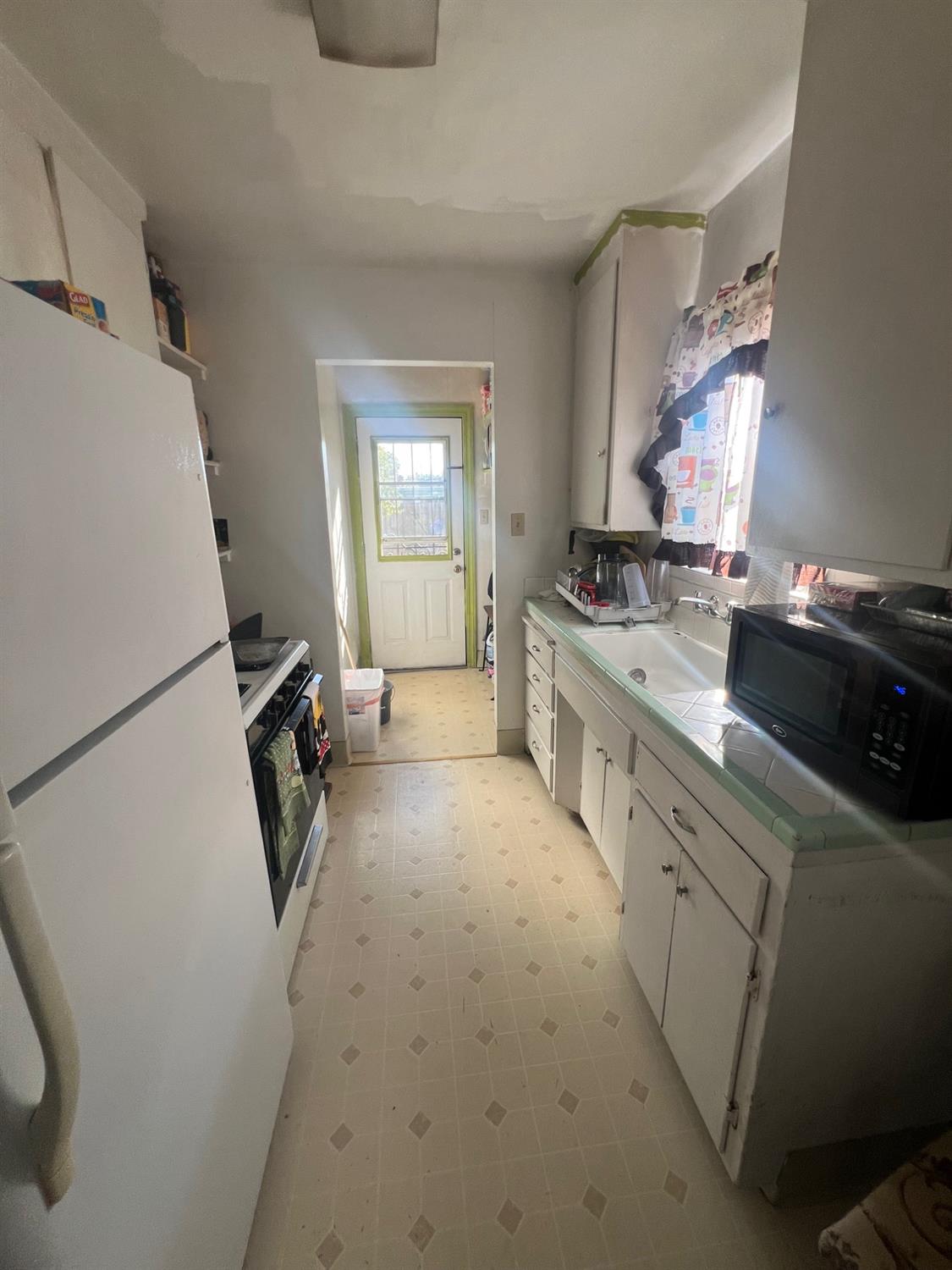 5202 Thurman Way Sacramento, CA 95824 - Photo 9 of 24 a kitchen with a sink appliances and cabinets