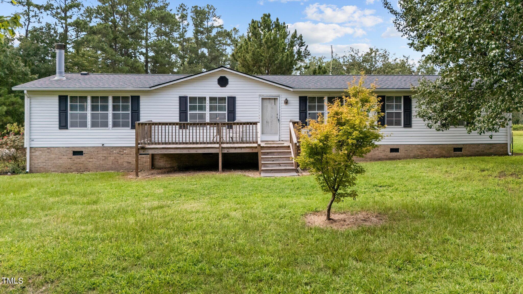 5612 Zacks Mill Road Angier, NC 27501 - Photo 1 of 42 a front view of a house with a garden