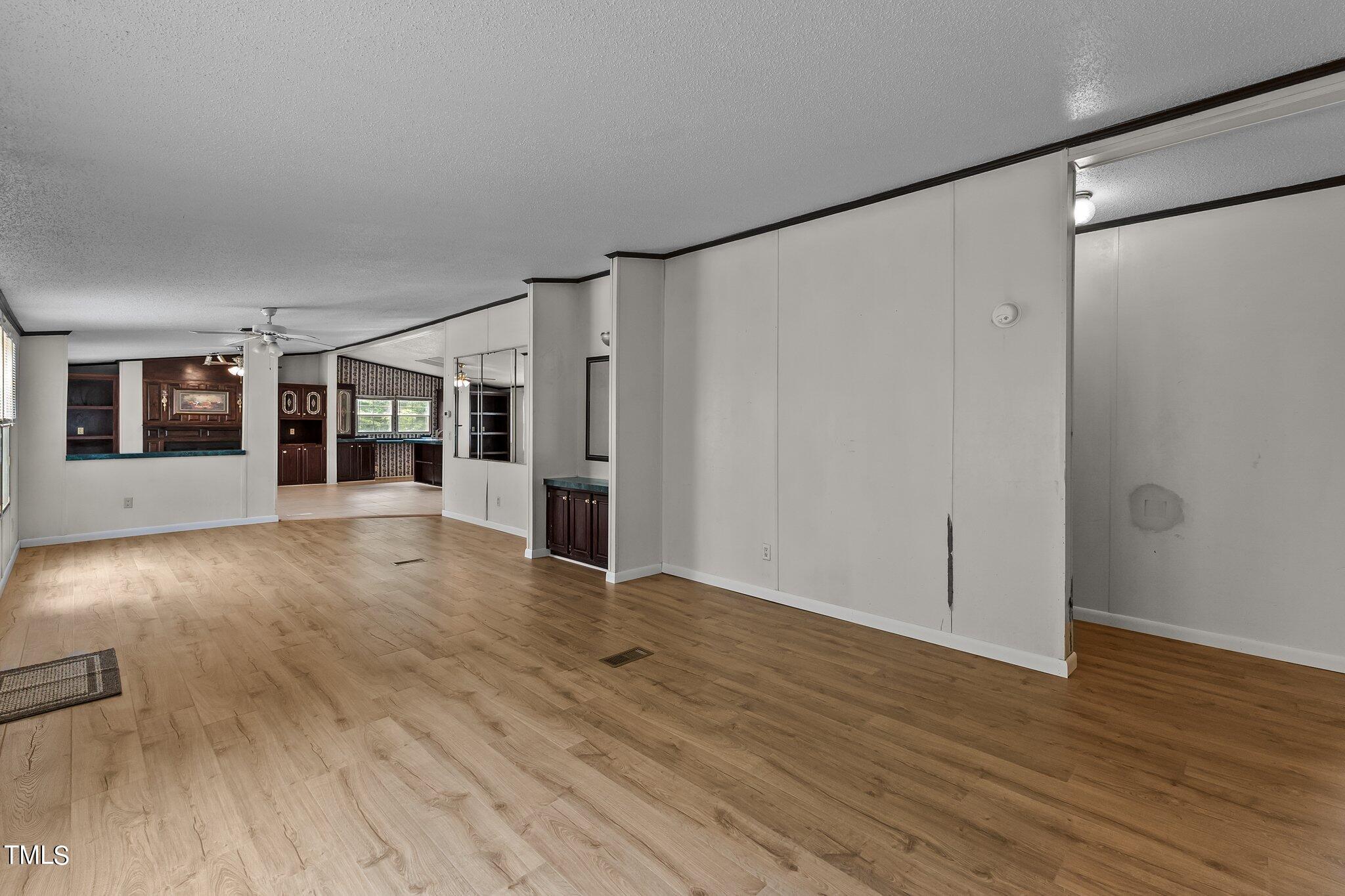 5612 Zacks Mill Road Angier, NC 27501 - Photo 16 of 42 a view of a big room with wooden floor and windows