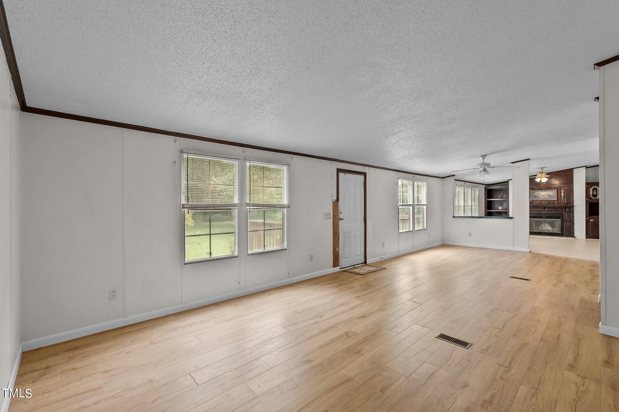 5612 Zacks Mill Road Angier, NC 27501 - Photo 17 of 42 a view of an empty room with window and wooden floor